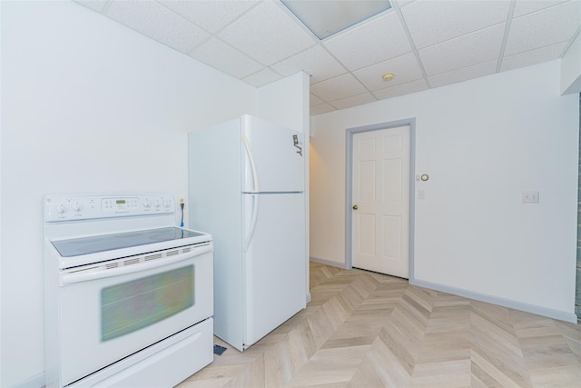 kitchen featuring light parquet flooring, a paneled ceiling, and white appliances