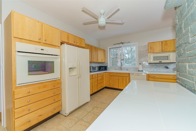 kitchen with ceiling fan, sink, white appliances, and tasteful backsplash