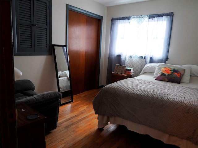 bedroom with light wood-type flooring and a closet