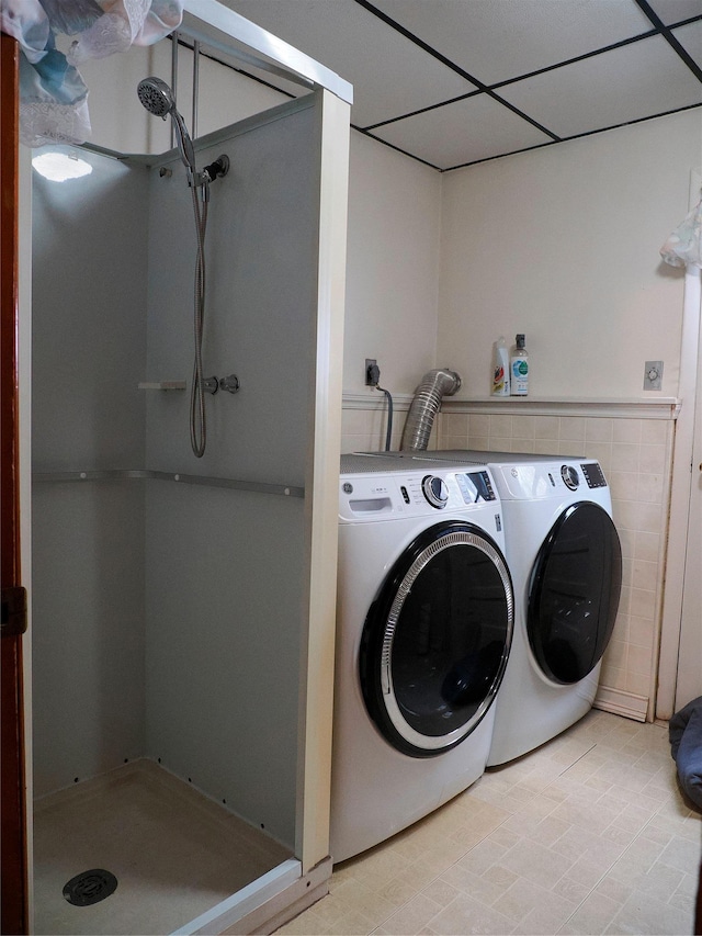washroom with washing machine and clothes dryer and laundry area