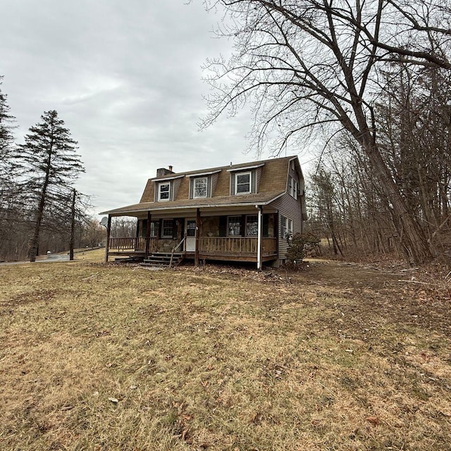 view of front of house featuring a front yard and a porch