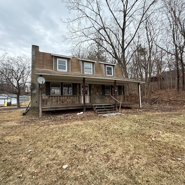 view of front of property with covered porch and a front lawn