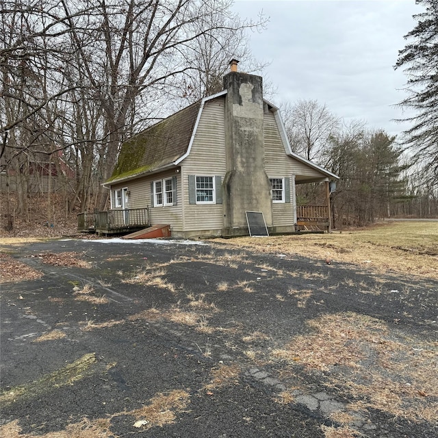 view of property exterior featuring a deck