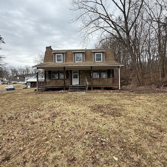 view of front of house with covered porch and a front yard