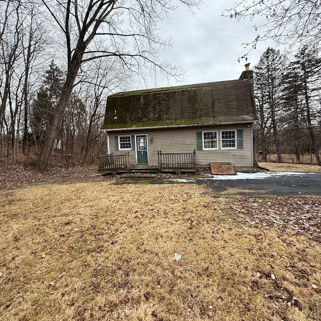 view of front of property with a front lawn and a wooden deck