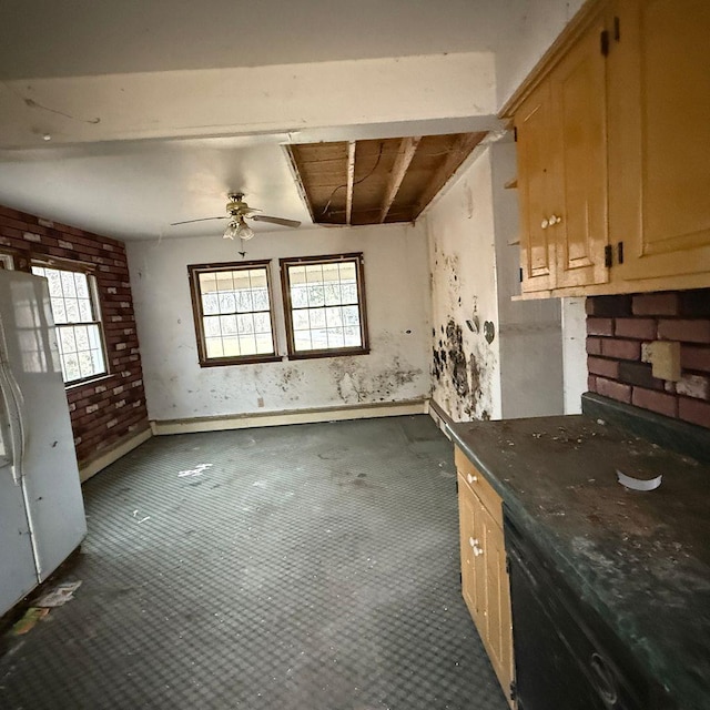 kitchen featuring white fridge, ceiling fan, light brown cabinets, and beamed ceiling