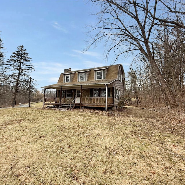 view of front facade featuring covered porch and a front yard