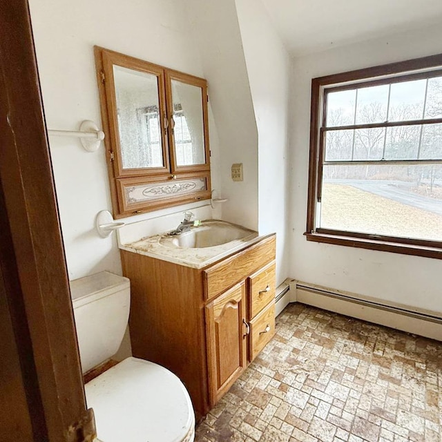 bathroom featuring a baseboard radiator, vanity, and toilet