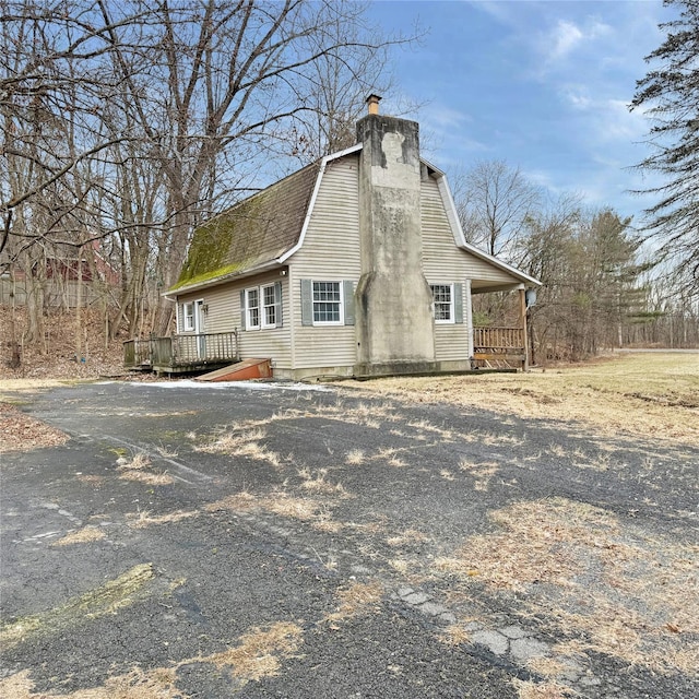 view of home's exterior featuring a wooden deck