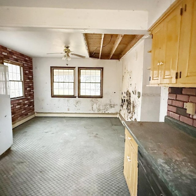 interior space featuring ceiling fan and brick wall