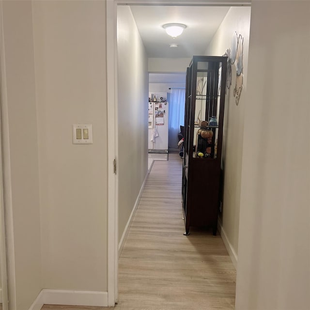 hallway with light wood-type flooring