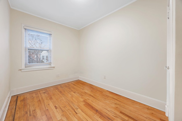 spare room featuring hardwood / wood-style floors and ornamental molding