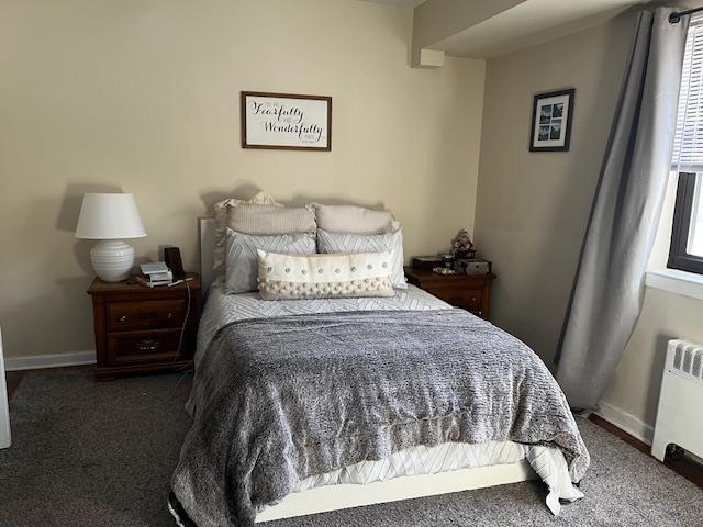 carpeted bedroom with radiator