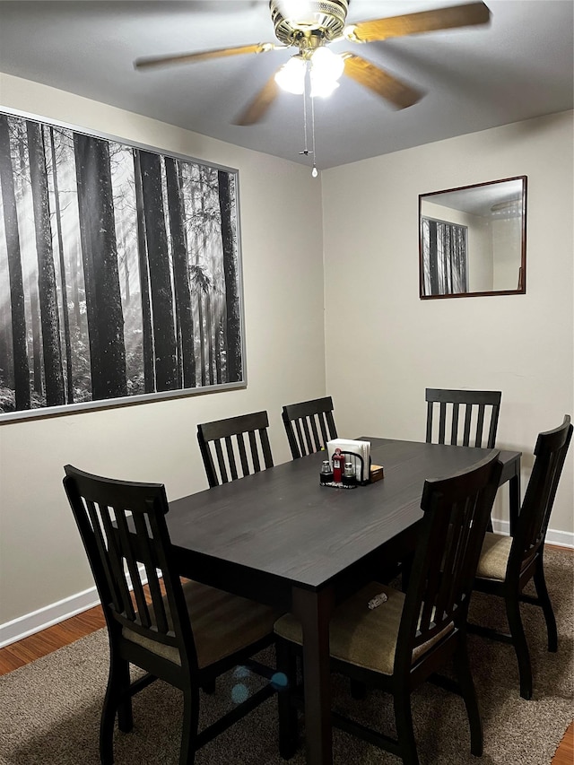 dining room with baseboards, a ceiling fan, and wood finished floors
