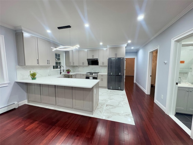 kitchen with kitchen peninsula, stainless steel range, range hood, pendant lighting, and sink