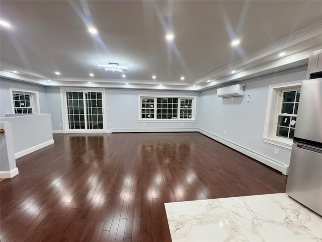 basement with baseboard heating, dark hardwood / wood-style floors, a wall mounted AC, and stainless steel refrigerator