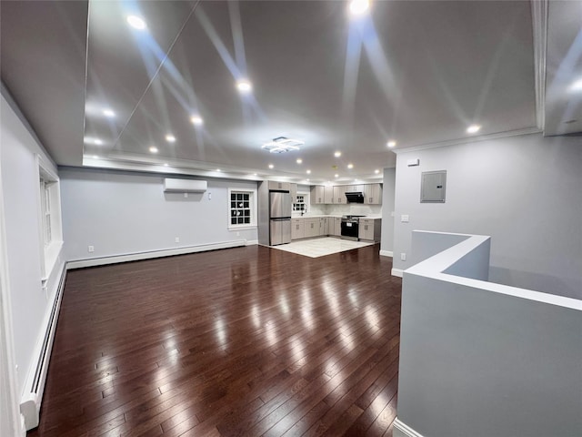 unfurnished living room with a wall mounted AC, a baseboard heating unit, dark hardwood / wood-style floors, and electric panel