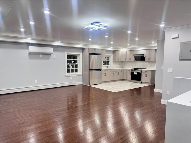 kitchen featuring appliances with stainless steel finishes, a baseboard heating unit, a wall mounted AC, electric panel, and gray cabinetry