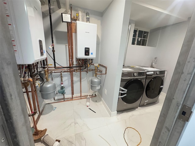 utility room with washer and dryer and tankless water heater