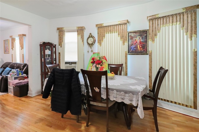 dining space with hardwood / wood-style floors and cooling unit