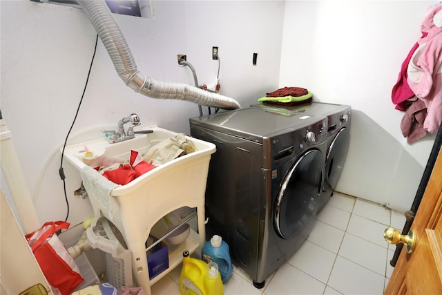 washroom featuring separate washer and dryer and light tile patterned floors