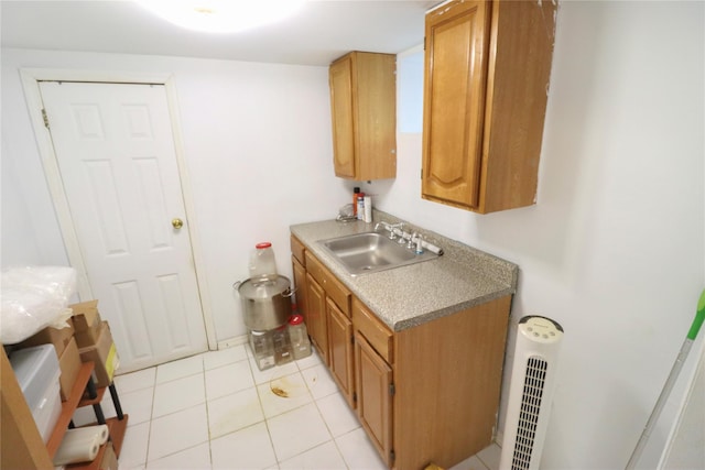 kitchen featuring light tile patterned floors and sink