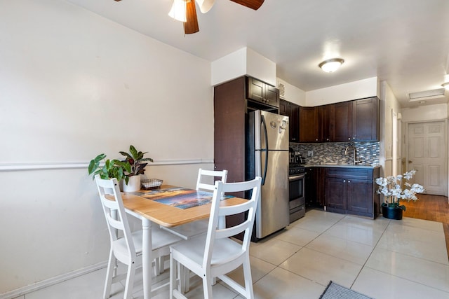 kitchen featuring appliances with stainless steel finishes, decorative backsplash, dark brown cabinets, and sink