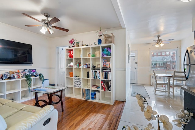 living room featuring hardwood / wood-style flooring and ceiling fan