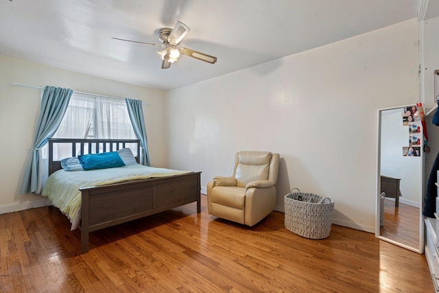 bedroom with ceiling fan and light hardwood / wood-style floors