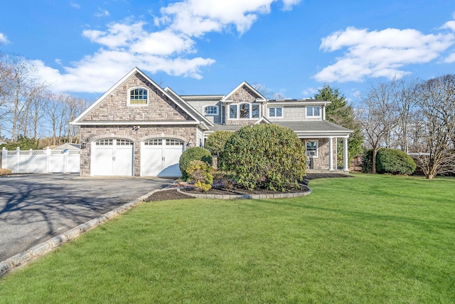 view of front of property with a front lawn and a garage