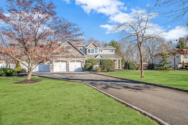 view of front facade featuring a front lawn and a garage