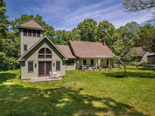 back of property featuring a yard and a patio