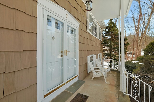 view of exterior entry featuring covered porch