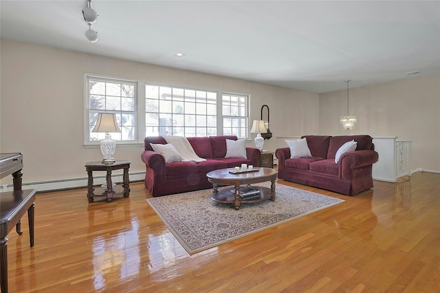 living room featuring a baseboard radiator and light wood-type flooring