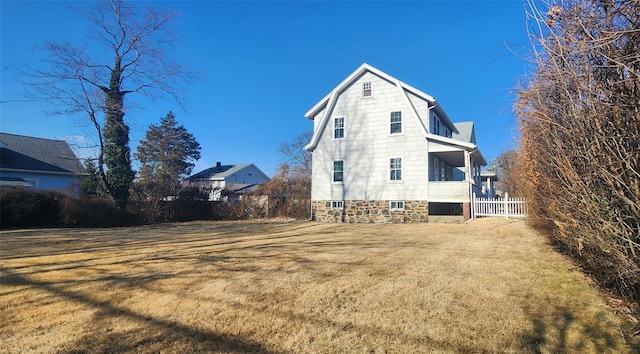 rear view of house featuring a lawn