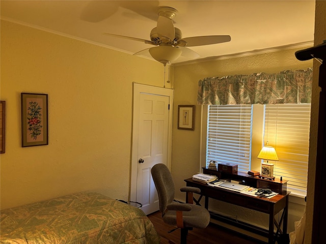 bedroom with crown molding, ceiling fan, and hardwood / wood-style flooring