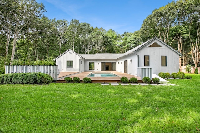 back of house with a yard and a swimming pool side deck