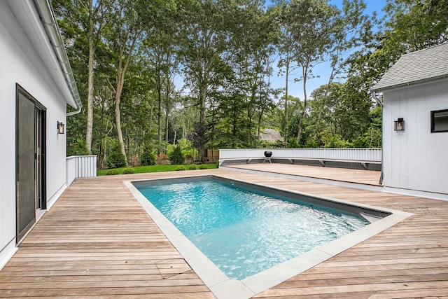 view of swimming pool featuring a wooden deck