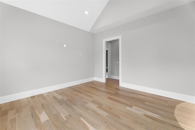 empty room featuring high vaulted ceiling and light hardwood / wood-style floors