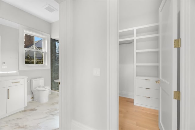 bathroom featuring vanity and toilet