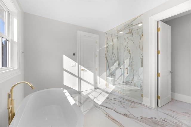 bathroom featuring plus walk in shower, plenty of natural light, and sink