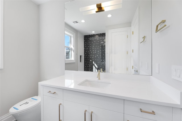 bathroom with vanity and toilet