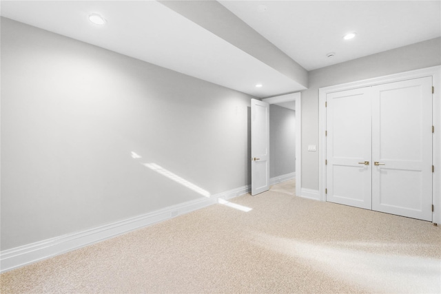 unfurnished bedroom with light carpet and a closet