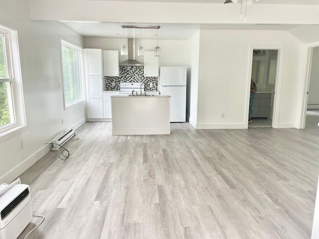 unfurnished living room featuring a baseboard radiator, an AC wall unit, sink, and light wood-type flooring