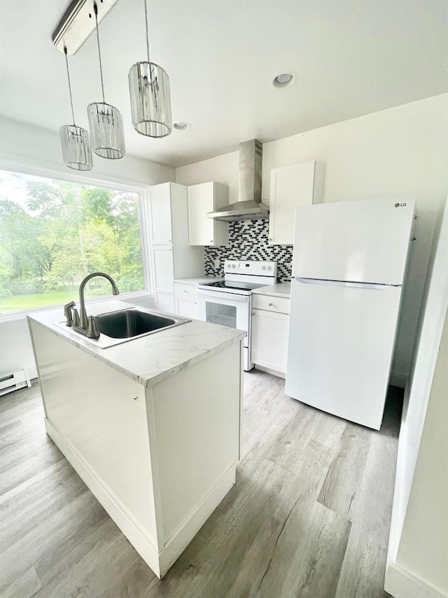 kitchen with wall chimney exhaust hood, white cabinetry, decorative light fixtures, an island with sink, and white appliances