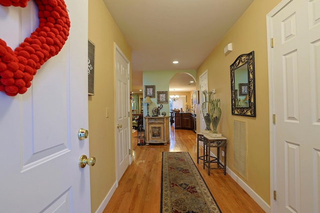 corridor with hardwood / wood-style floors