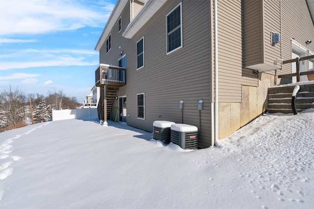 view of snowy exterior with central AC