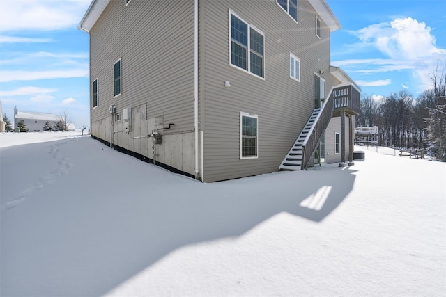 view of snow covered exterior with central AC