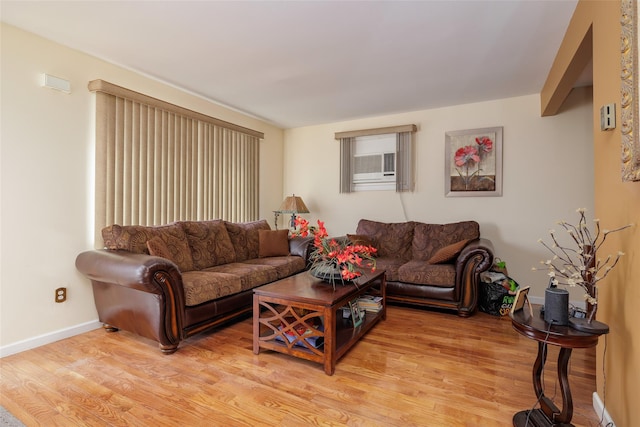 living room featuring cooling unit and light hardwood / wood-style flooring