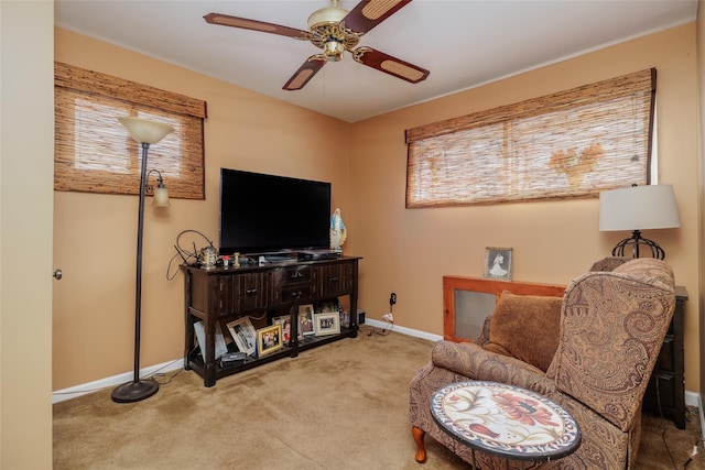 living area with carpet flooring and ceiling fan